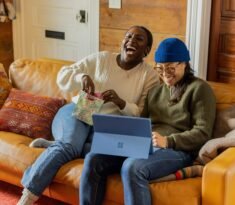 a person sitting on a couch with a laptop