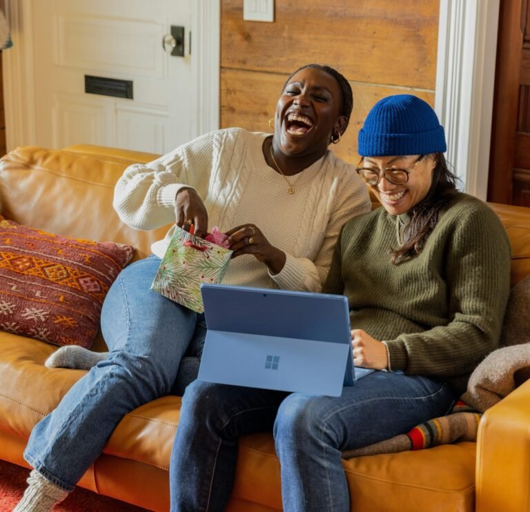 a person sitting on a couch with a laptop