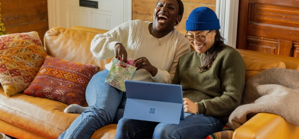 a person sitting on a couch with a laptop